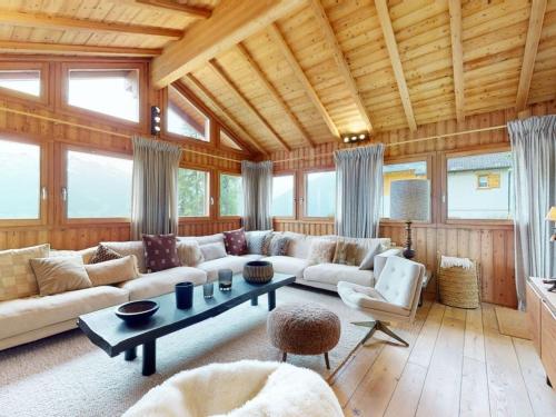 a living room with a couch and a table at Beautiful chalet in Le Bouveret with garden in Hérémence