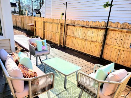 a patio with chairs and tables and a fence at Beautiful home in Chesapeake in Chesapeake