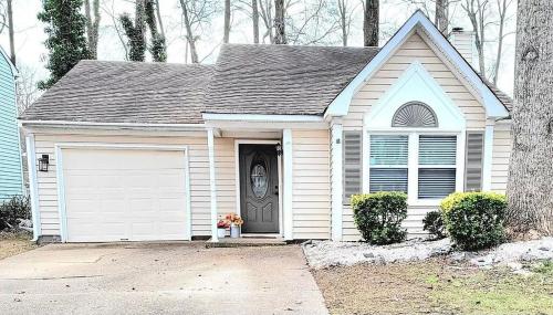a small white house with a white garage at Beautiful home in Chesapeake in Chesapeake