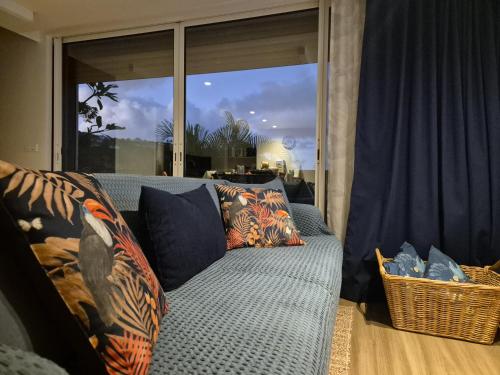 a couch sitting in front of a large window at Blue Hideaway in Saint Barthelemy