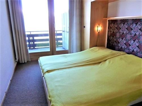 a bedroom with a bed and a large window at Apartment in Veysonnaz near Ski Gondola in Veysonnaz