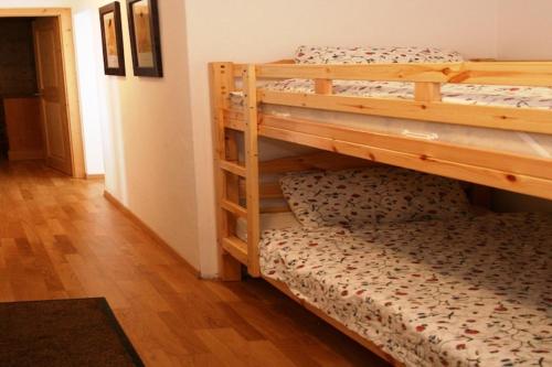 a couple of bunk beds in a room at Traditional apartment with balcony in Veysonnaz