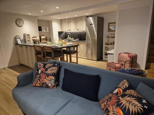 a living room with a blue couch and a kitchen at Blue Hideaway in Saint Barthelemy