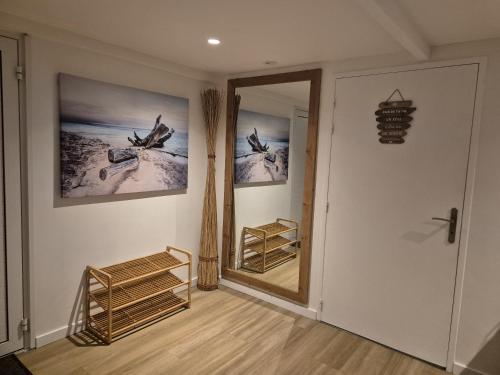 a room with a hallway with a mirror and birds on the wall at Blue Hideaway in Saint Barthelemy