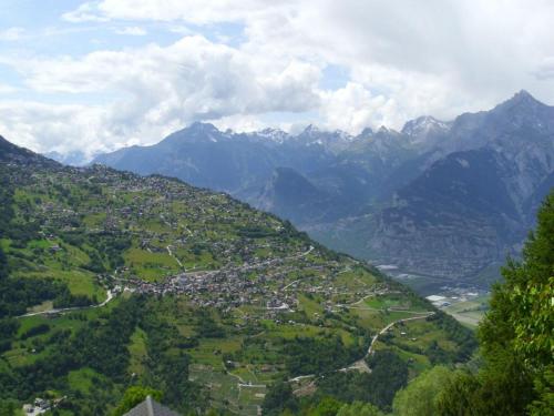 a view of a town in a valley with mountains at Sunny chalet in Veysonnaz for 10 guests in Veysonnaz