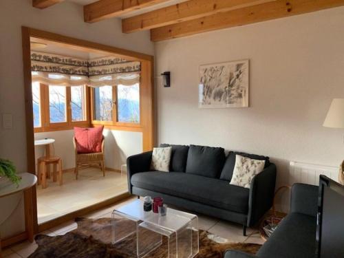 a living room with a couch and a table at Sunny chalet in Veysonnaz for 10 guests in Veysonnaz
