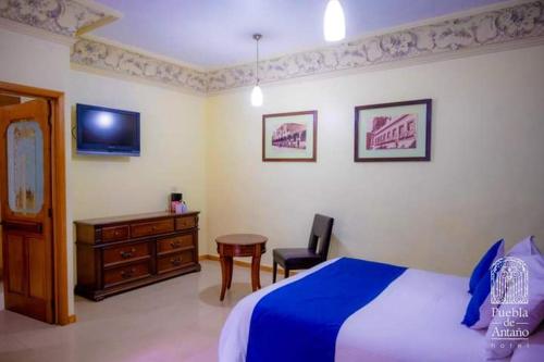 Ένα ή περισσότερα κρεβάτια σε δωμάτιο στο Hotel Puebla de Antaño