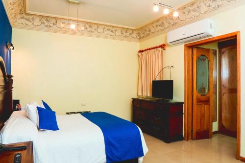 Ένα ή περισσότερα κρεβάτια σε δωμάτιο στο Hotel Puebla de Antaño