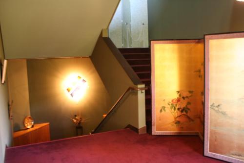 a staircase in a house with a stair case at Nisshokan Bettei Koyotei in Nagasaki
