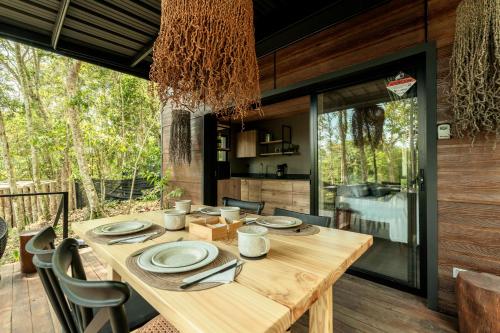 a dining room with a wooden table and chairs at El Bosque - Lago Calima in Calima