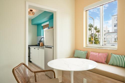 a kitchen with a white table and a window at Aloha Fridays in Miami Beach