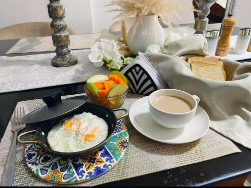 a table with a bowl of eggs and a cup of coffee at Hospedaje Rosa Blanca in Cartagena de Indias