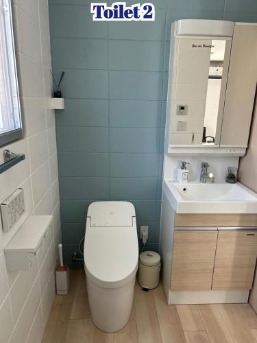 a bathroom with a toilet and a sink at Sea Side Loco's in Yaka