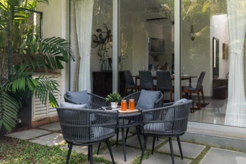 a table and chairs sitting on a patio at La Olalian 2 & 3 BHK Designer Villas Near Anjuna Beach with Private Pool & Sun Deck & Garden in Anjuna