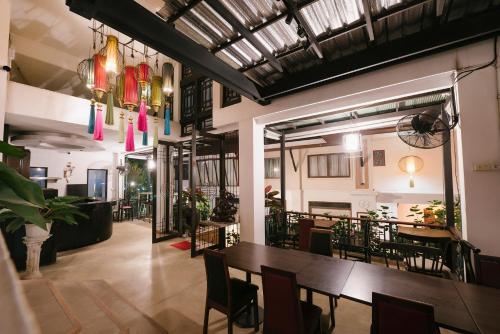 a dining room with a table and chairs at La Seine City Resort, Chiang Mai in Chiang Mai
