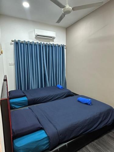Кровать или кровати в номере ILoveHoliday Homestay Sri Kepayan
