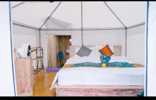 クブペンロカンにあるLa Danu Glampingのテントの中にベッドがある寝室