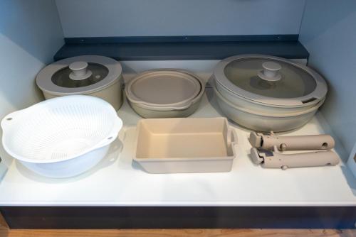 a drawer filled with bowls and other kitchen utensils at TKD HOUSE Furano 2 in Furano