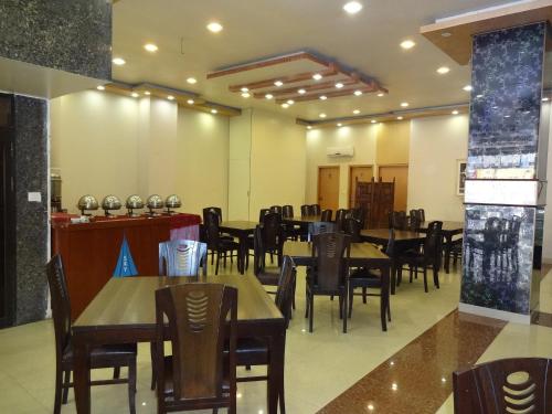 a restaurant with tables and chairs in a room at Hotel Sky Towers in Karachi