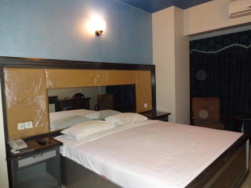 a bedroom with two beds and a telephone in it at Hotel Sky Towers in Karachi