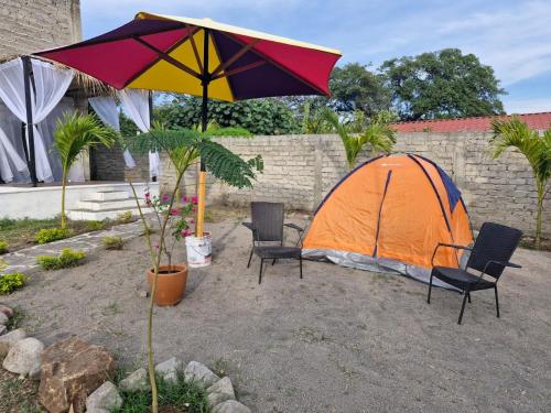 an orange tent and two chairs and an umbrella at Cabaña Las Luciérnagas in El Parián