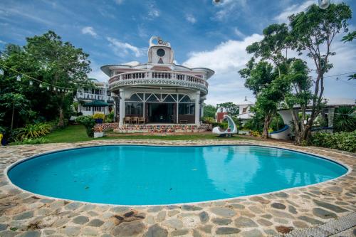an image of a swimming pool in front of a house at Casa de Arte in Boracay