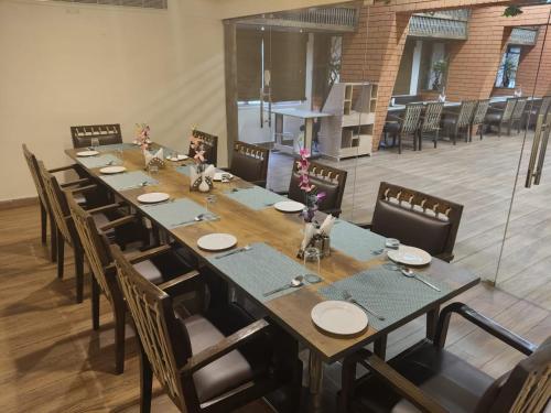 a long dining room with a long table and chairs at Eastin Dè Royalè in Hyderabad