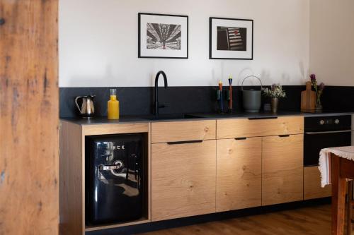 a kitchen with a sink and a dishwasher at Villa Hod Couples Suite with Mountain Views in ‘En Hod