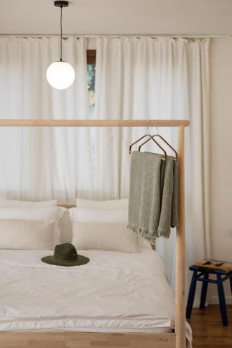 a bedroom with a bed with a hat on it at Villa Hod Couples Suite with Mountain Views in ‘En Hod
