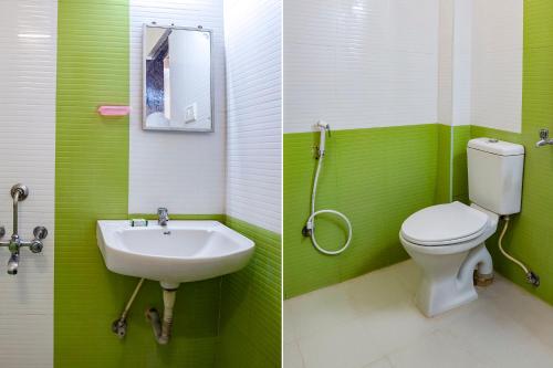 a green bathroom with a toilet and a sink at FabExpress Home Tree Service Apartment T Nagar - Near Mambalam Railway Station in Chennai