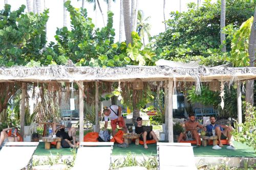 a group of people sitting in a pavilion at EVA HUT Mui Ne Beach Hostel in Mui Ne