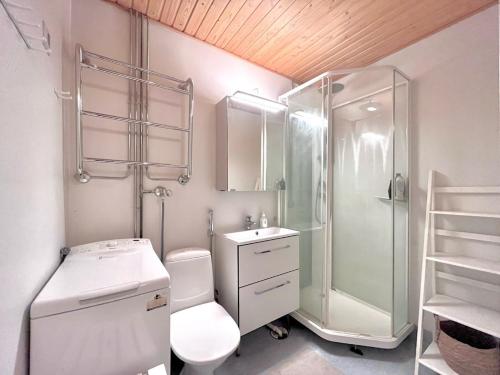 a bathroom with a shower and a toilet and a sink at Cozy Studio next to Metro & Mall in Espoo