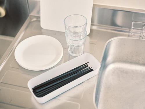 a kitchen counter with a knife and a plate and a sink at vetta kumamoto sakuramachi 702 in Kumamoto