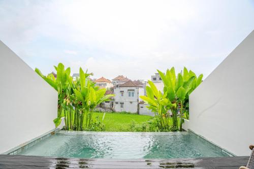 a view from the balcony of a house with a swimming pool at Jiva Loft Style Villa in Canggu