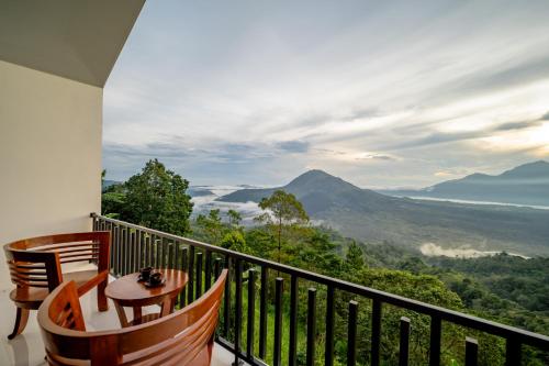 a balcony with a table and chairs and a view at Tegal Sari Cabin Kintamani in Kintamani