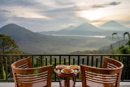 a table with food on top of a balcony with mountains at Tegal Sari Cabin Kintamani in Kintamani