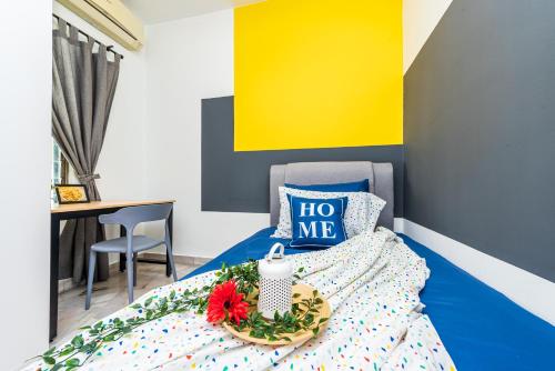 a bedroom with a bed with a tray of flowers on it at 7 min to Sunway Pyramid Deluxe Room Shared House at PJS9 in Petaling Jaya