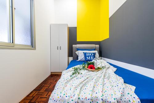 a bedroom with a bed with a bowl of fruit on it at 7 min to Sunway Pyramid Deluxe Room Shared House at PJS9 in Petaling Jaya
