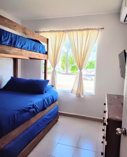 a bedroom with two bunk beds and a window at Casas Marina Turquesa in Cancún
