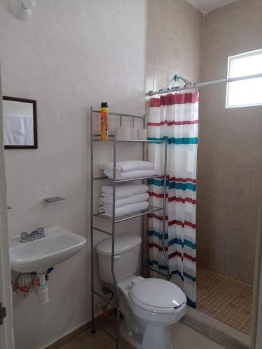 a bathroom with a toilet and a sink and a shower at Casas Marina Turquesa in Cancún