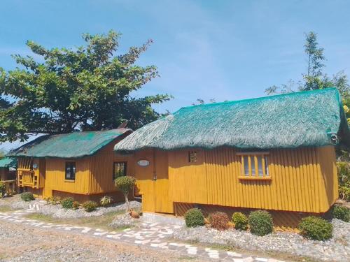 a model of a house with a green roof at Seabreeze Beachfront Home and Cottages new management in San Juan