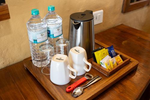 a wooden table with a tray with water bottles at Bar Peepal Resort in Pokhara