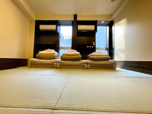 a room with four mattresses stacked on top of each other at Andon Ryokan in Tokyo