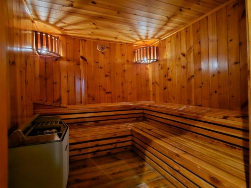 an empty wooden sauna with a trash can in it at Al Faris Suites 2 in Juffair