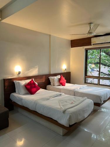 Postel nebo postele na pokoji v ubytování Hotel Samrat, Kolhapur