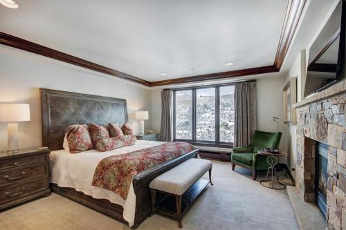 a bedroom with a large bed and a fireplace at Luxury Ski-In 3 Br Penthouse Inside Pines Lodge, Sleeps 10! Condo in Beaver Creek