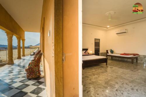 a bedroom with a bed and a checkerboard floor at Arman Desert Luxury Camp & Resort Jaisalmer in Jaisalmer