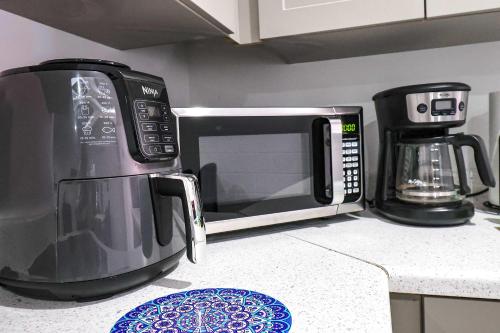 a microwave sitting on top of a kitchen counter at NEW RENOVATED STUDIO Nr UCF PETSOK PRIVATE ENTRY in Orlando