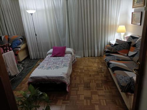 a living room with a bed and a couch at Habitacion Alameda de Osuna Madrid Aeropuerto in Madrid