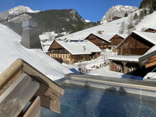 a resort with a swimming pool in the snow at Terra-Beka Lodge in La Chapelle-dʼAbondance